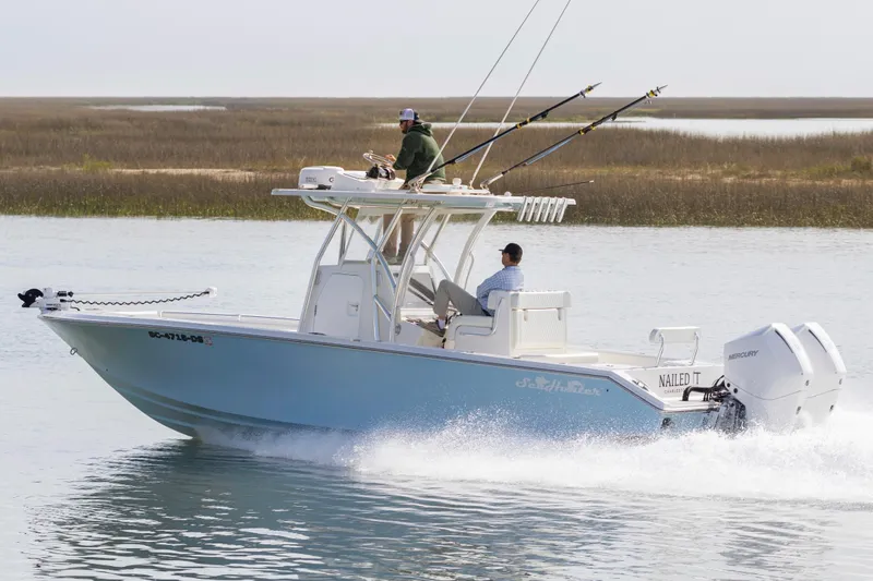Slide: The Image of 2021 SeaHunter 28 Floridian boat cruising on water with fishing rods and dual Mercury engines. - 4