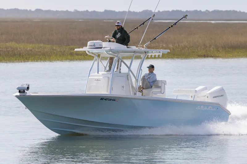 Slide: The Image of 2021 SeaHunter 28 Floridian boat cruising on water with two people onboard. - 8