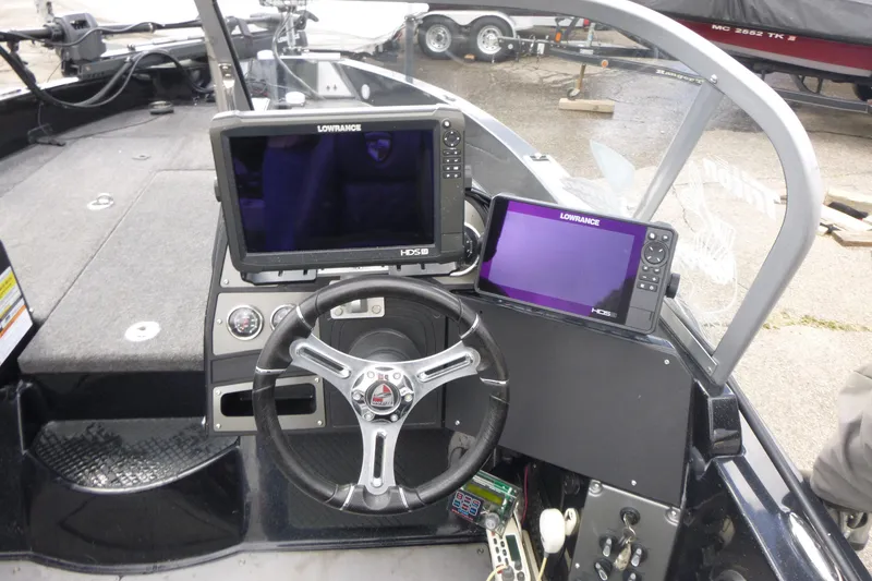 Slide: The Image of 2019 Triton 206 Allure boat dashboard with Lowrance HDS displays and steering wheel. - 15