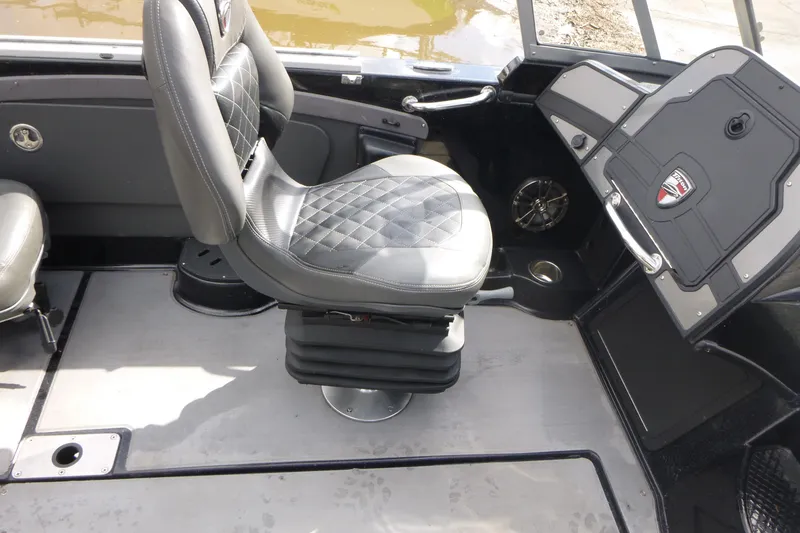 Slide: The Image of 2019 Triton 206 Allure boat interior with cushioned seating and control panel. - 18