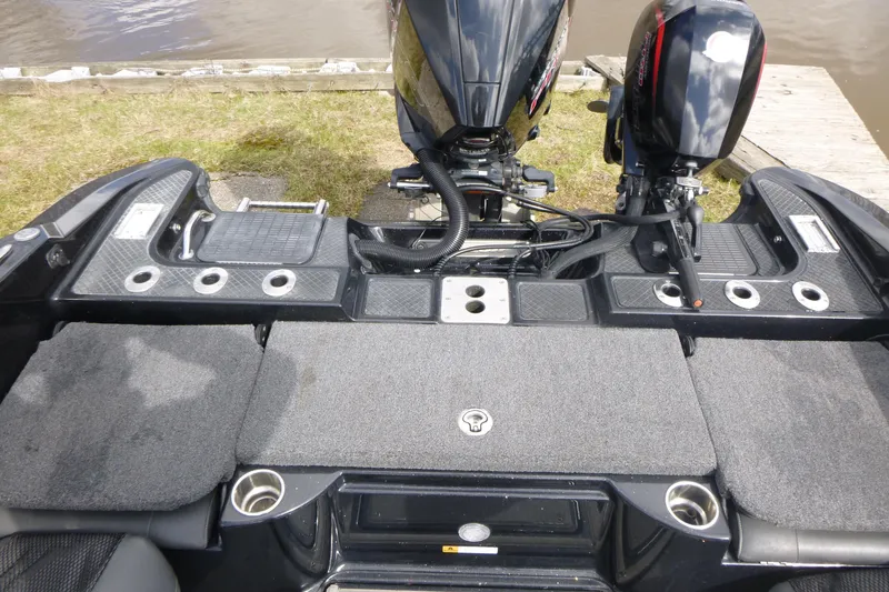 Slide: The Image of 2019 Triton 206 Allure boat deck with dual motors and fishing rod holders. - 20