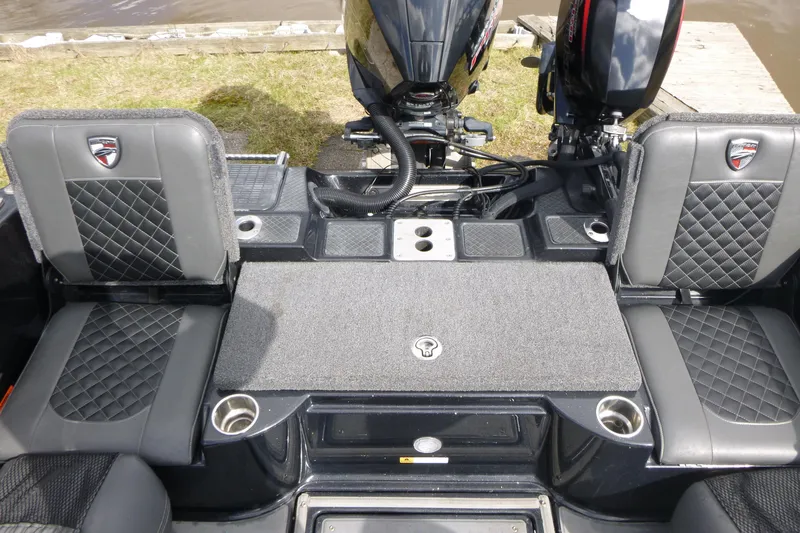 Slide: The Image of 2019 Triton 206 Allure boat interior with dual seats and motor view. - 21