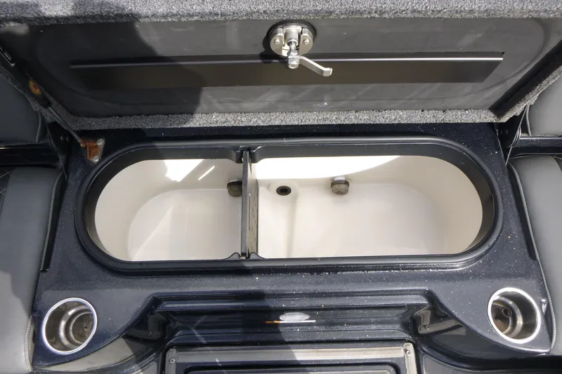 Slide: The Image of 2019 Triton 206 Allure boat livewell with open lid and cup holders. - 22