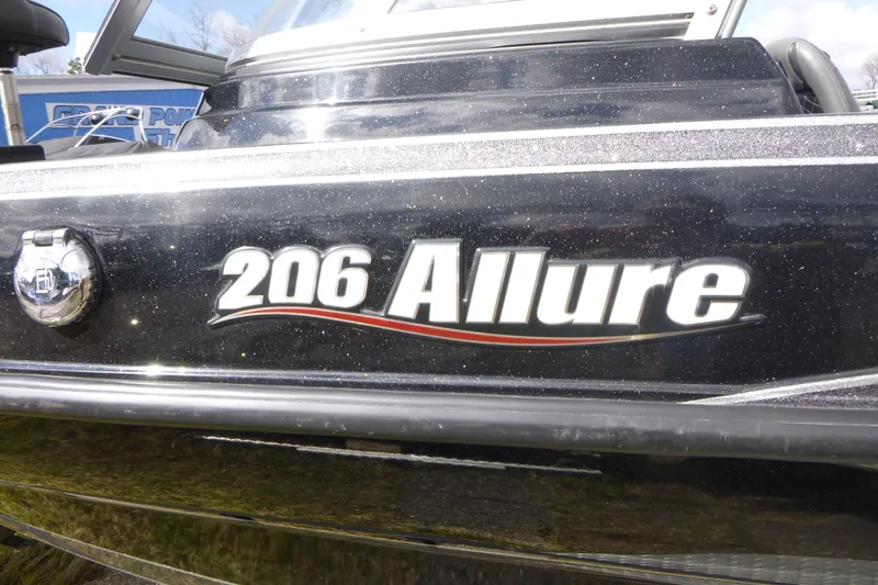 Slide: The Image of 2019 Triton 206 Allure boat with sleek black exterior and bold lettering. - 25