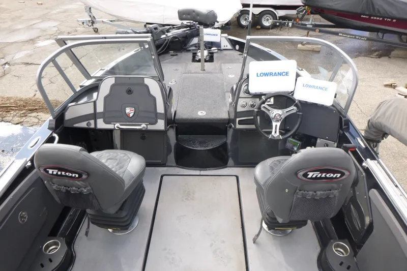 Slide: The Image of 2019 Triton 206 Allure boat interior with Lowrance electronics and Triton-branded seats. - 5