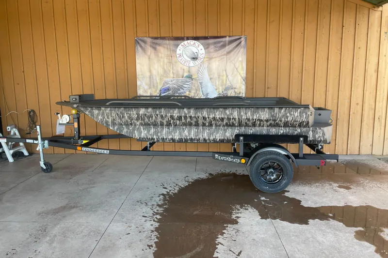 The Image of 2026 Reaper Boats 553 Timber Reaper on trailer, camouflage design, displayed outdoors. - 1