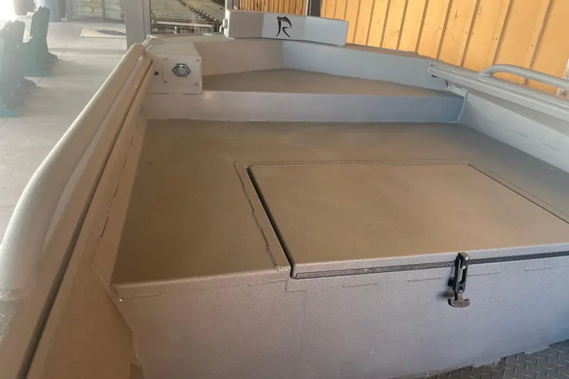 Slide: The Image of 2026 Reaper Boats 553 Timber Reaper interior, showcasing spacious deck and storage compartment. - 12