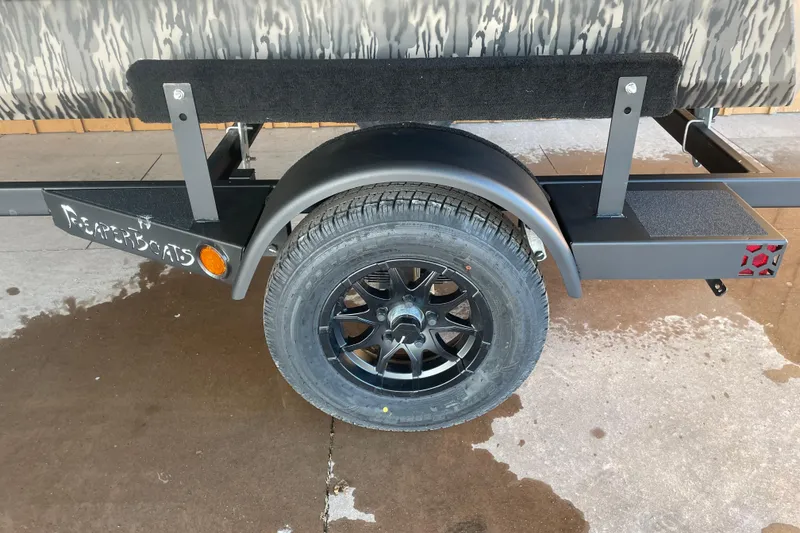 Slide: The Image of Trailer wheel of 2026 Reaper Boats 553 Timber Reaper, featuring black alloy rim. - 8