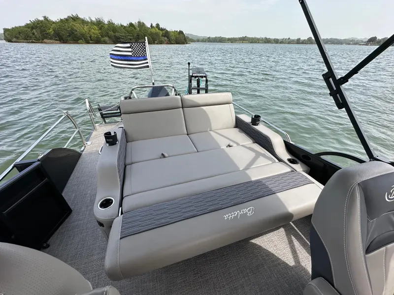 Slide: The Image of 2023 Barletta Corsa 23UC pontoon boat with sunbed on a scenic lake. - 17