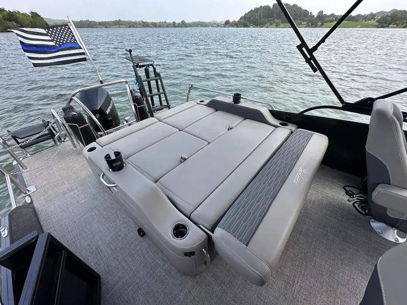 Slide: The Image of 2023 Barletta Corsa 23UC pontoon boat with spacious seating on a scenic lake. - 18