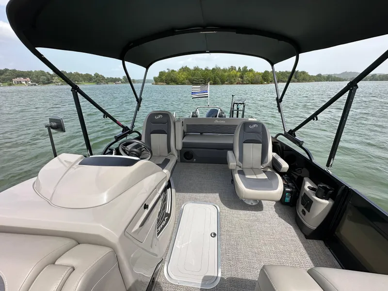 Slide: The Image of 2023 Barletta Corsa 23UC pontoon boat interior on a scenic lake. - 25