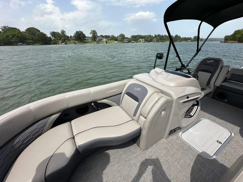 Slide: The Image of 2023 Barletta Corsa 23UC pontoon boat interior on a lake. - 26