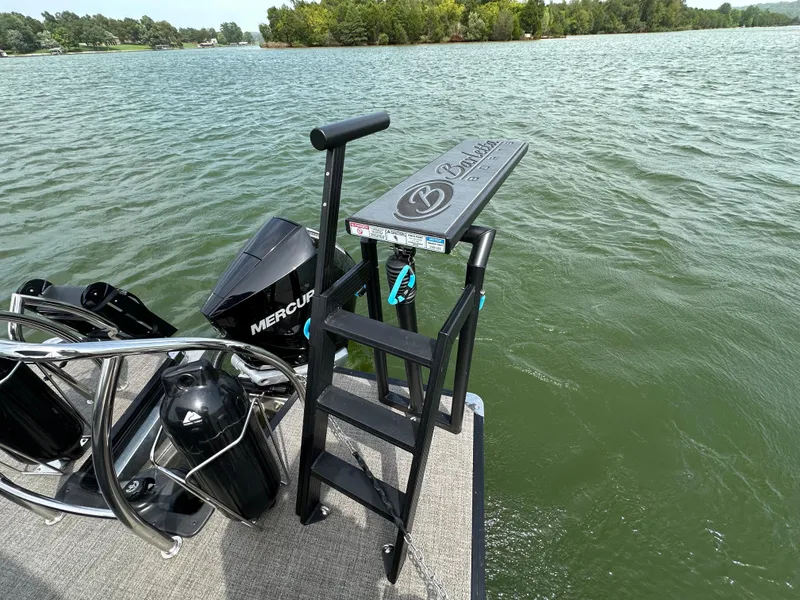 Slide: The Image of 2023 Barletta Corsa 23UC boat with ladder and Mercury engine on a lake. - 30