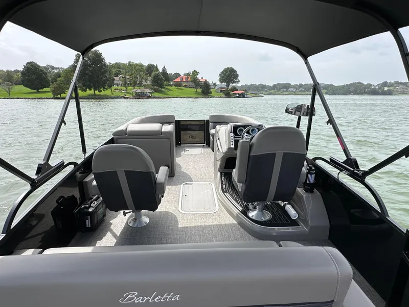 Slide: The Image of 2023 Barletta Corsa 23UC pontoon boat interior on a scenic lake. - 31