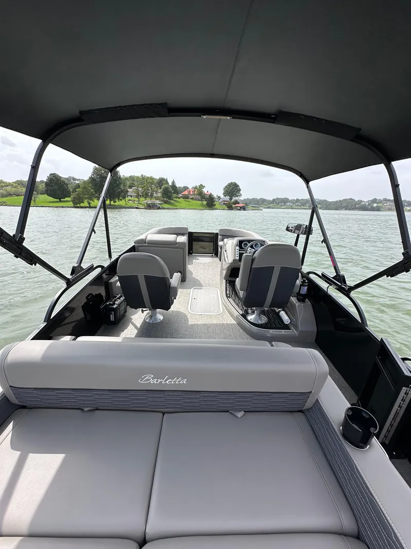Slide: The Image of 2023 Barletta Corsa 23UC pontoon boat interior on a lake. - 32