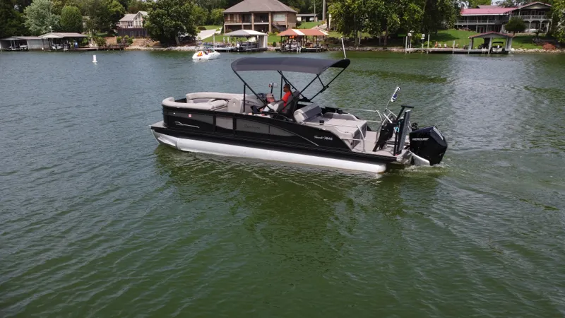 Slide: The Image of 2023 Barletta Corsa 23UC pontoon boat cruising on a scenic lake. - 4