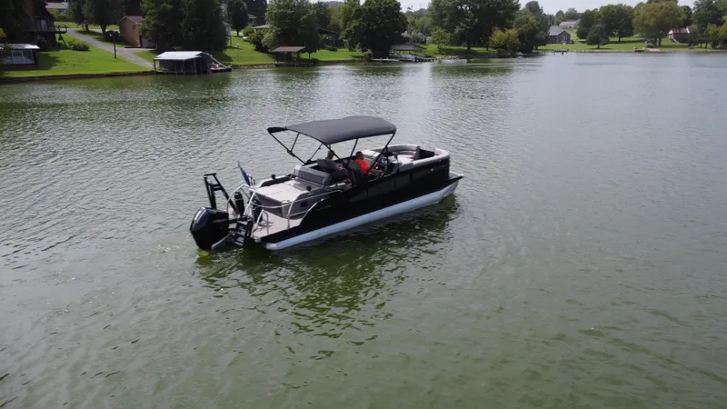 Slide: The Image of 2023 Barletta Corsa 23UC pontoon boat on a serene lake. - 5