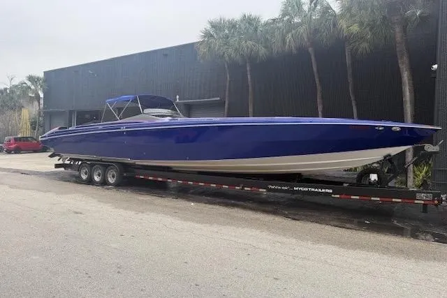 Slide: The Image of 2007 Nor-Tech 5000V powerboat on trailer, sleek blue design, parked outdoors. - 3
