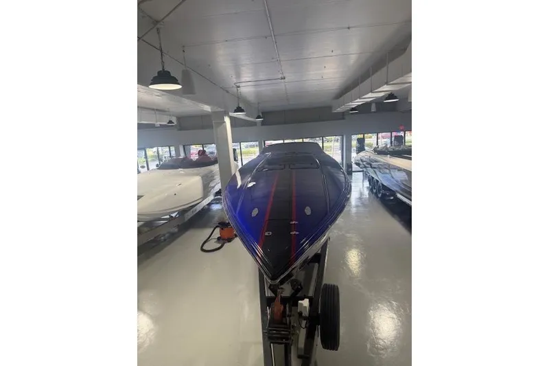Slide: The Image of 2007 Nor-Tech 5000V powerboat in showroom, featuring sleek blue design. - 5