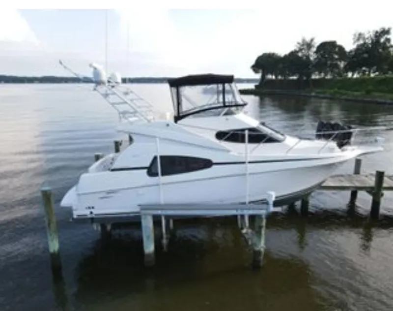 Slide: The Image of 2002 Silverton 330 yacht docked on a calm lake. - 1