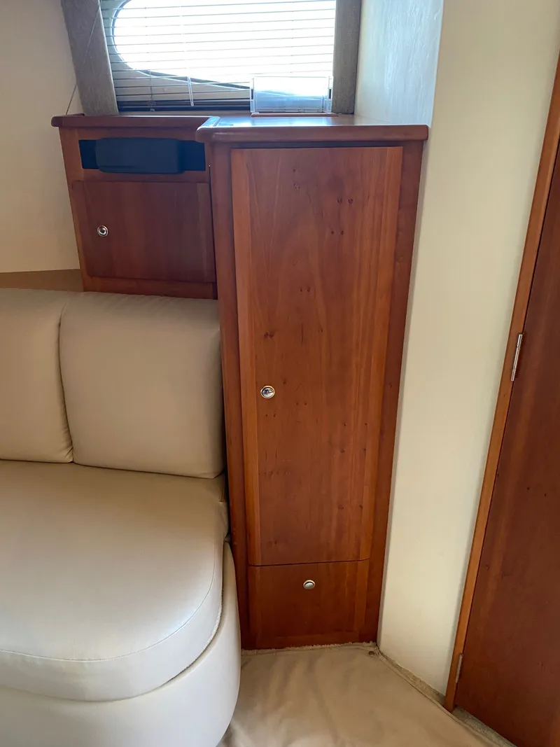 Slide: The Image of Interior of a 2002 Silverton 330 with wooden cabinetry. - 20