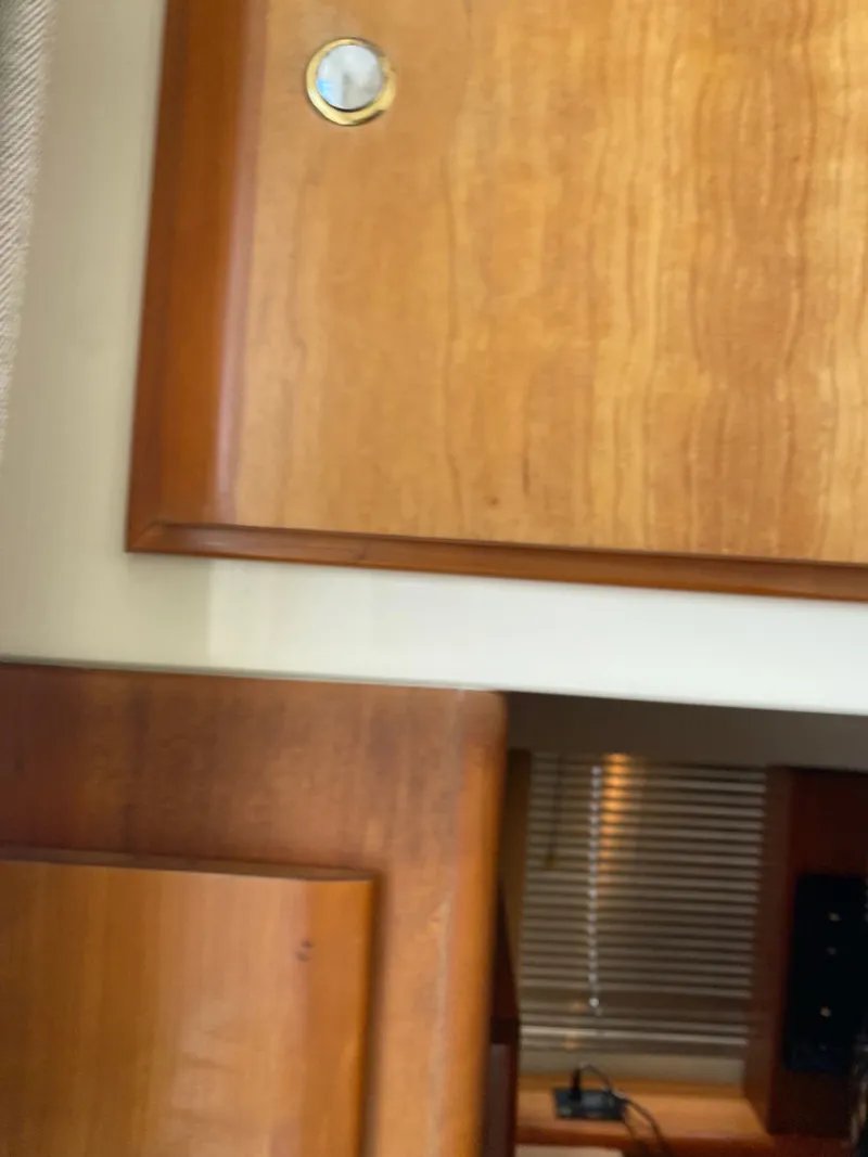 Slide: The Image of Interior of a 2002 Silverton 330 boat with wooden cabinetry. - 30