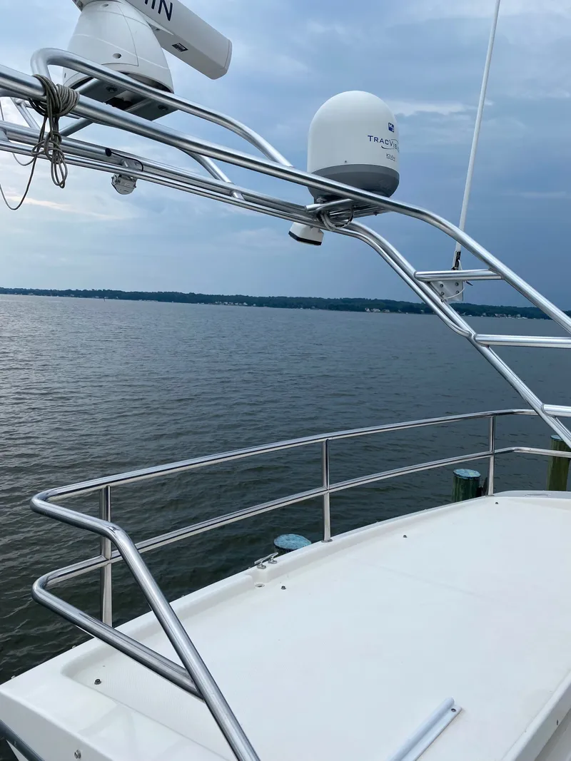 Slide: The Image of 2002 Silverton 330 yacht on calm waters under cloudy sky. - 46