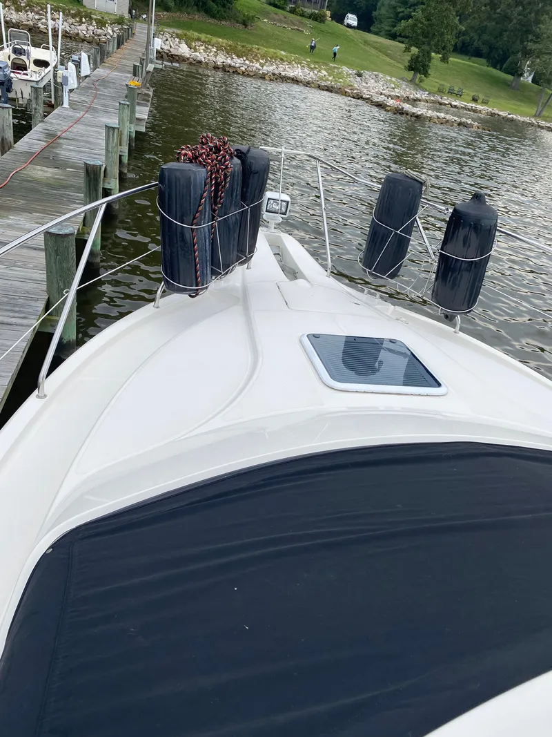 Slide: The Image of 2002 Silverton 330 boat docked with fenders. - 8