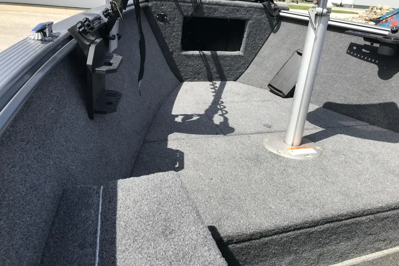 Slide: The Image of 2007 Lund 1425 Classic Tiller boat interior with carpeted flooring and seating area. - 13