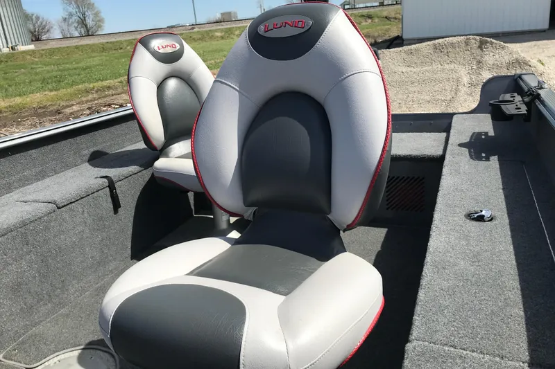 Slide: The Image of 2007 Lund 1425 Classic Tiller boat seats, featuring gray and white upholstery with red accents. - 14