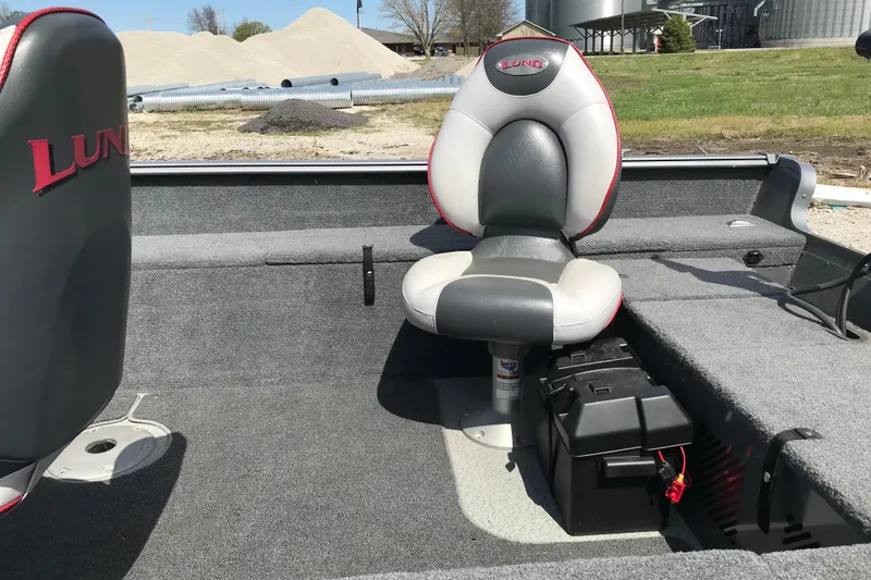 Slide: The Image of 2007 Lund 1425 Classic Tiller boat interior with cushioned seating and storage compartments. - 15