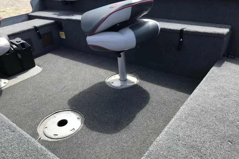 Slide: The Image of 2007 Lund 1425 Classic Tiller boat interior with gray carpet and swivel seat. - 16