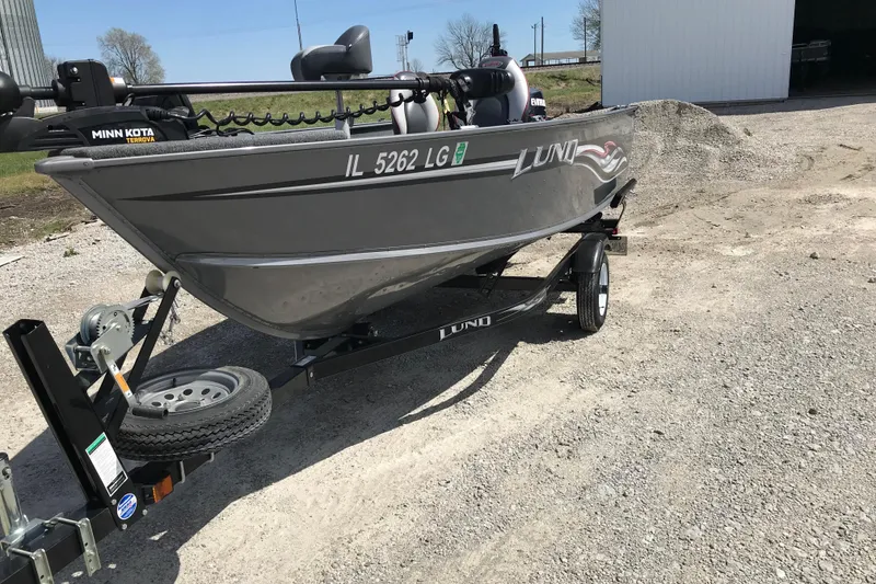 Slide: The Image of 2007 Lund 1425 Classic Tiller boat on trailer, parked outdoors. - 3