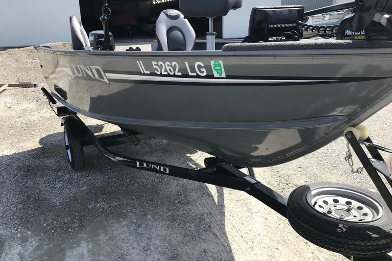 Slide: The Image of 2007 Lund 1425 Classic Tiller boat on trailer, parked outdoors. - 4