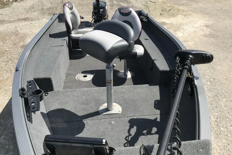 Slide: The Image of 2007 Lund 1425 Classic Tiller boat interior with seating and motor. - 5