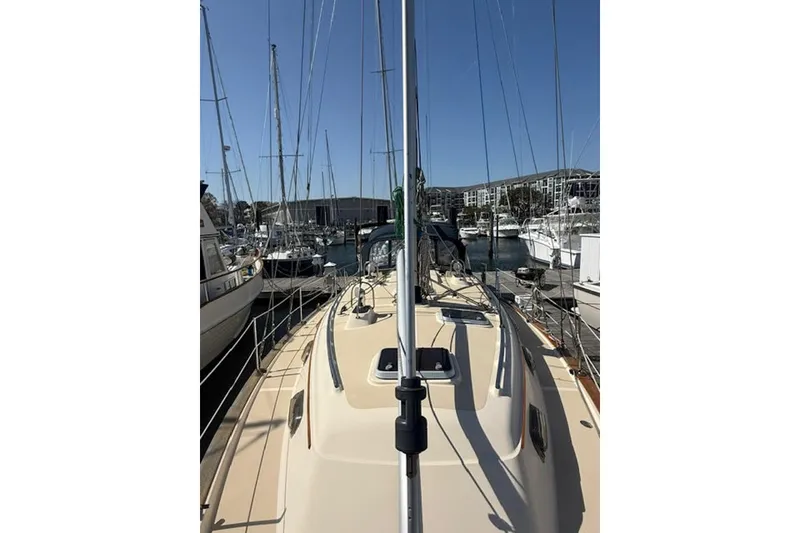 Slide: The Image of 2001 Island Packet 380 sailboat docked in a marina, surrounded by other boats. - 10