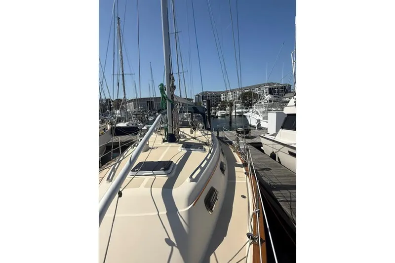 Slide: The Image of 2001 Island Packet 380 sailboat docked in a marina under clear blue skies. - 11
