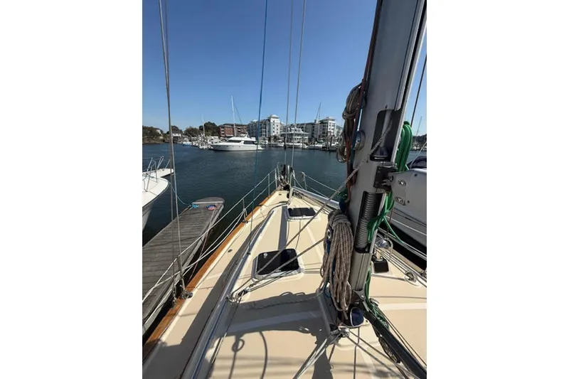 Slide: The Image of 2001 Island Packet 380 sailboat docked in a marina, clear sky, calm waters. - 13