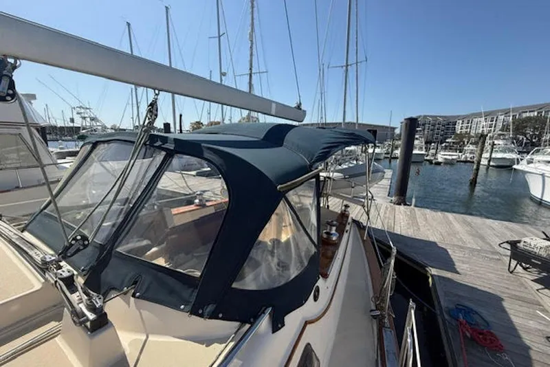 Slide: The Image of Island Packet 380 sailboat, 2001 model, docked at a marina with blue canopy. - 14