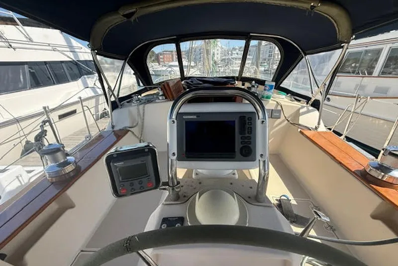Slide: The Image of Cockpit of 2001 Island Packet 380 sailboat with navigation equipment and steering wheel. - 15