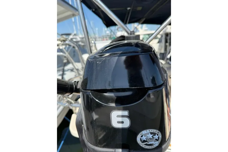 Slide: The Image of Close-up of a black outboard motor with "6" and "Ultra Low Emission" label. - 18