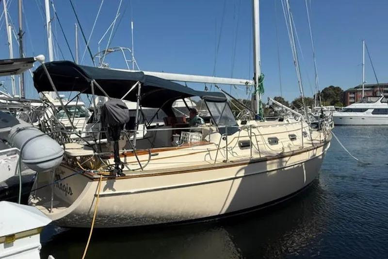 Slide: The Image of 2001 Island Packet 380 sailboat docked in a marina under clear blue skies. - 2