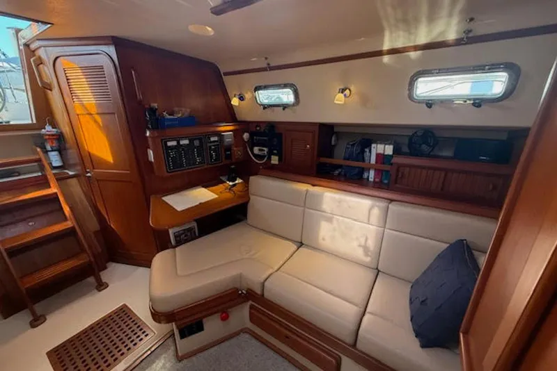 Slide: The Image of Interior of 2001 Island Packet 380 sailboat with cozy seating and wooden cabinetry. - 25
