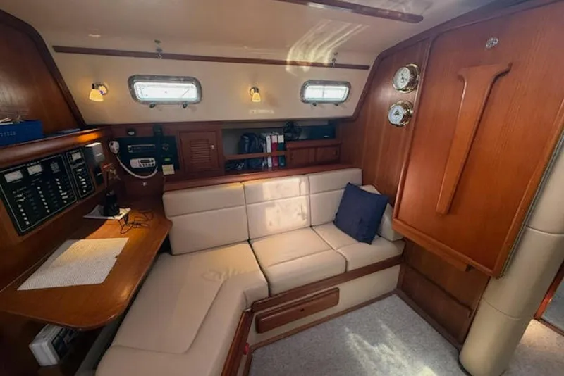 Slide: The Image of Interior of 2001 Island Packet 380 sailboat with cozy seating and wooden cabinetry. - 27