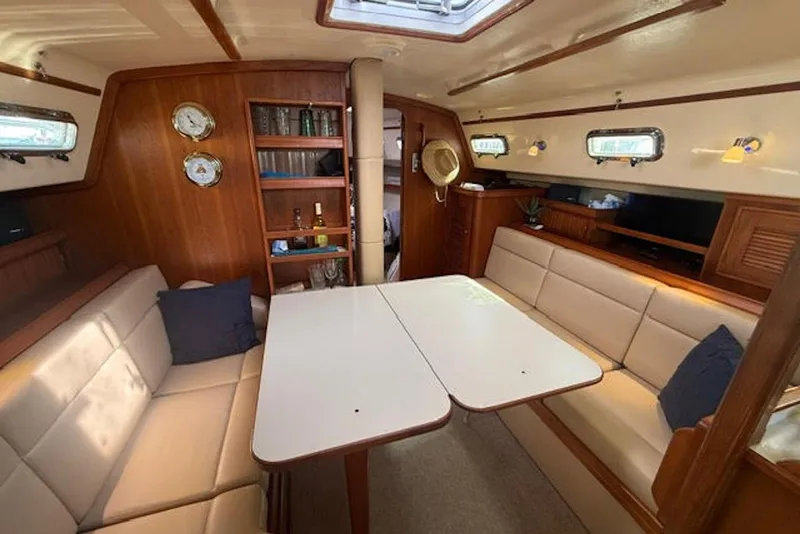 Slide: The Image of Interior of 2001 Island Packet 380 sailboat with cozy seating and wooden accents. - 29