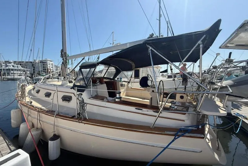 Slide: The Image of 2001 Island Packet 380 sailboat docked at marina under clear blue sky. - 3