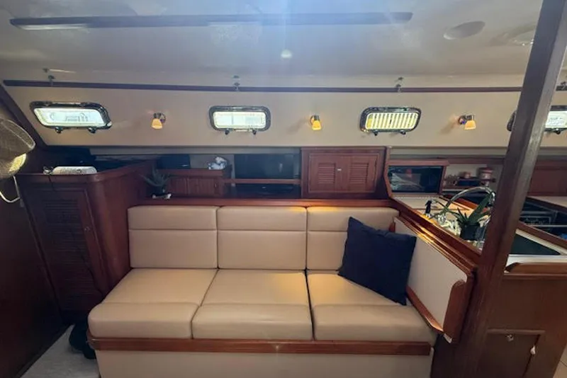 Slide: The Image of Interior of 2001 Island Packet 380 sailboat with beige seating and wooden accents. - 30