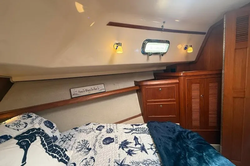 Slide: The Image of Cozy cabin interior of 2001 Island Packet 380 sailboat with nautical decor and wooden cabinetry. - 38