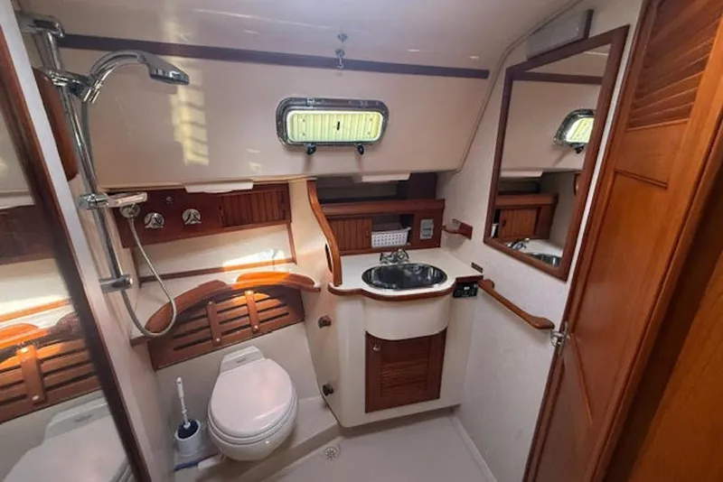 Slide: The Image of Interior of 2001 Island Packet 380 yacht bathroom with sink, toilet, and shower. - 39