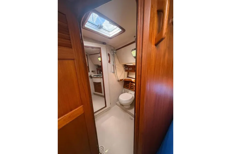 Slide: The Image of Interior view of 2001 Island Packet 380 yacht bathroom with wooden accents. - 42